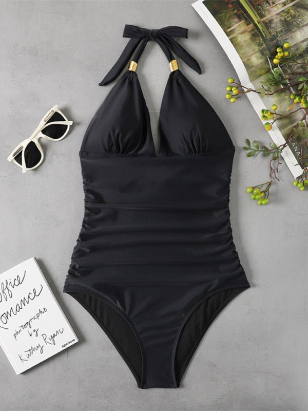 Black halter one‑piece swimsuit laid flat, showing back tie details and flattering fit