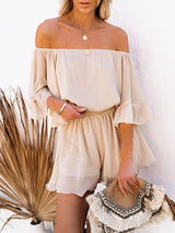 Model wearing the Adelaide Chiffon Playsuit in Pearl, styled with a clutch bag