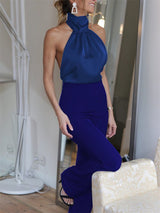 Front view of The Blathin Jumpsuit in blue, styled for an elegant evening look.