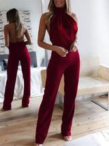 Rear view of burgundy Blathin Jumpsuit, showing open back design and high-waisted trousers.