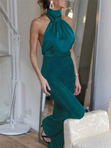 The Blathin Jumpsuit in emerald green, styled with heels for a statement outfit.