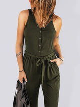 Model wearing Caprice Buttoned Jumpsuit in olive green, holding a handbag