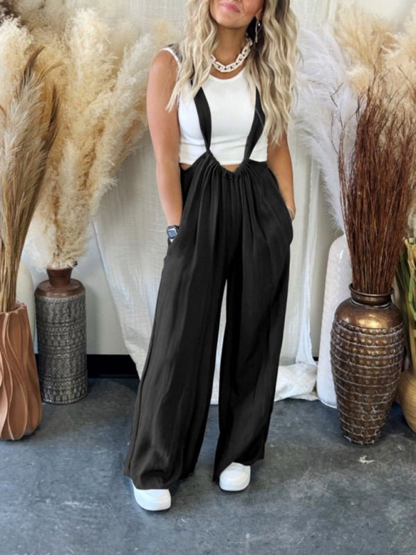 Black Etana Overall Jumpsuit with wide legs and playful back tie, styled for casual chic.