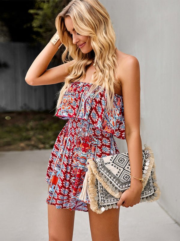 Model holding a clutch and wearing The Freya Strapless Playsuit in boho print for a summer-ready look.