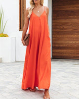 Woman wearing The Harlot Jumpsuit in vibrant orange, front view, wide-leg summer jumpsuit with spaghetti straps.