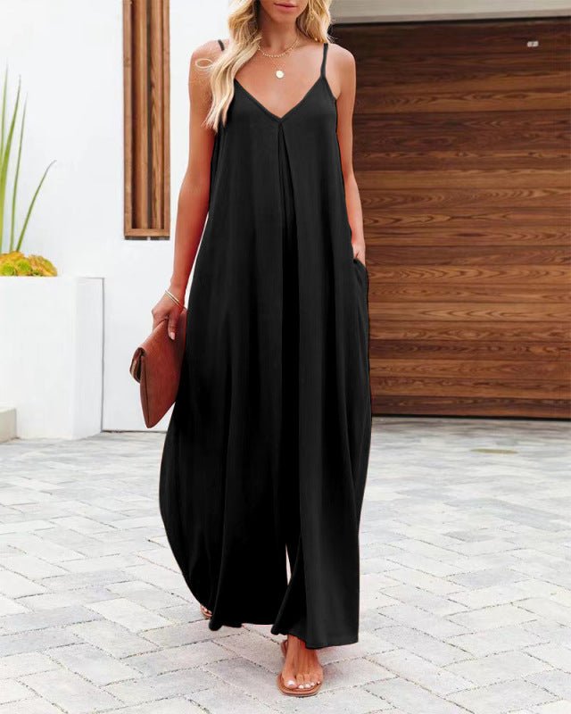 Woman wearing The Harlot Jumpsuit in classic black, front view, wide-leg v-neck summer jumpsuit.